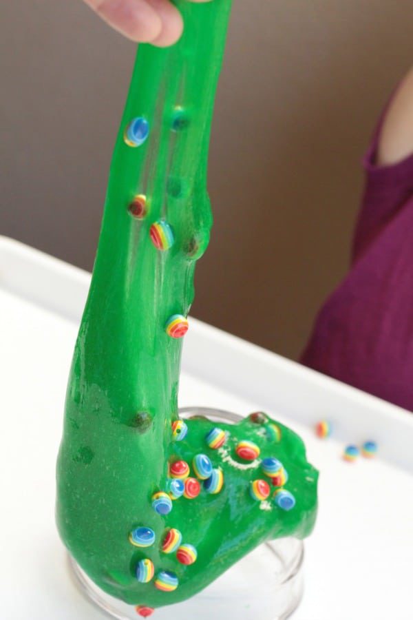 This rainbow bead sensory slime recipe is perfect for St. Patrick's Day or any time of year! Rainbow fun and stretchy slime fun!