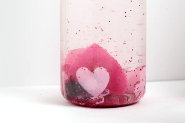 Try this fun Valentine discovery bottle to learn about magnets, technology, and science in this simple preschool STEM activity for Valentine's Day!