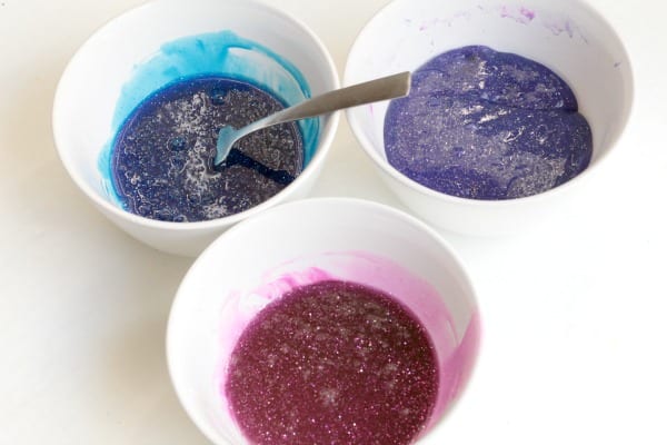 Blue, purple, and pink galaxy slime before it is mixed.