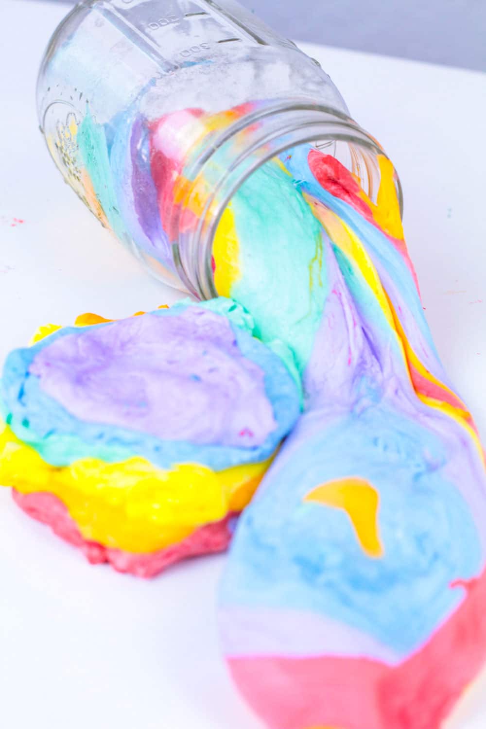 Slime lovers will adore this fluffy version of rainbow slime! This fluffy rainbow slime recipe is super easy to make and it's less messy than many other slime recipes out there. Rainbow slime that is fluffy is fun and you'll learn how to make fluffy rainbow slime in no time!