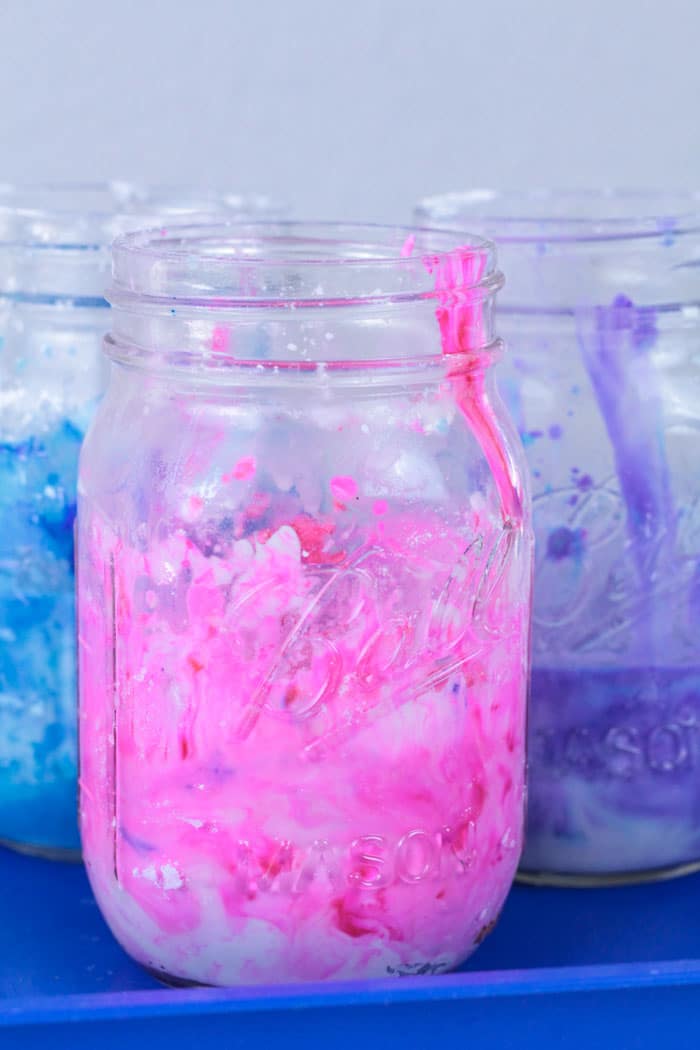 Make science fun with the galaxy oobleck science experiment. Kids will love this bright galaxy colored version of their favorite science experiment. It's the perfect summer science experiment to try at home with kids! Science experiments for kids are super fun this summer! #stem #stemed #science #scienceexperiments #summer #summerfun #summeractivities
