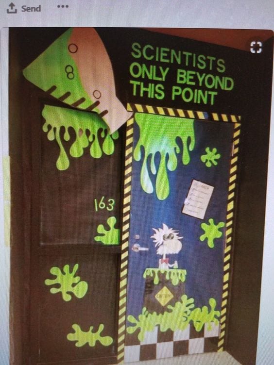 A classroom door for halloween that is decorated with slime and a flask that says "scientists only beyond this point"