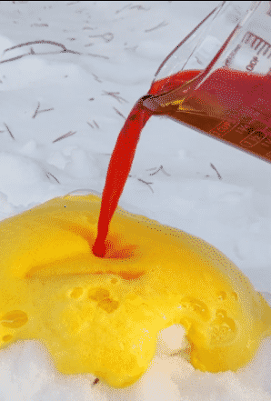 pouring vinegar into snow volcano